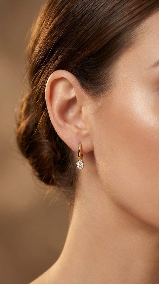 Gouden solitaire oorbellen